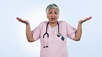 Confused, decision and mature doctor in studio with hand gesture for doubt, choice and options. Healthcare, nurse and portrait of woman shrug for question, unsure and uncertainty on blue background