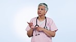 Confused, pointing and face if doctor in studio with hand gesture for decision, choice and options. Healthcare, nurse and portrait of woman for yes, promotion and advertising on blue background