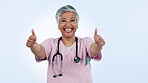 Healthcare, smile and thumbs up with an old woman nurse in studio on a blue background for support. Portrait, medical and motivation with a medicine professional happy to gesture a yes or like emoji