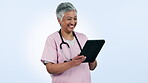 Doctor, woman and tablet for medical planning, clinic results and schedule or telehealth services in studio. Professional mature nurse laughing on digital tech or healthcare meme on a blue background