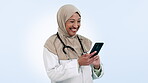 Doctor, happy woman and phone for healthcare communication, social media meme and telehealth services in studio. Muslim nurse or medical worker in Saudi Arabia laughing on mobile and blue background