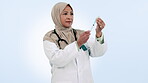 Medical doctor, muslim woman and needle in studio for healthcare, medicine or wellness. Hijab, mature and professional person with a syringe, injection and white background with liquid treatment