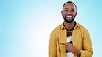 Pointing, mockup and face of black man on blue background for promotion, advertising and choosing. Banner, happy and portrait of person with hand gesture for option, agreement and decision in studio