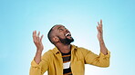 Wow, face and a black man on a blue background with celebration, success or a win. Happy, deal and portrait of an African person or winner looking up with hands raised for a surprise or achievement