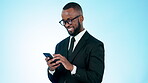 Happy businessman, phone and typing in social media, communication or networking against a studio background. Black man or business employee smile for online chatting or texting on mobile smartphone