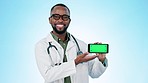 Face, doctor or green screen of cellphone in studio for advertising, results or show telehealth information to you on blue background. Portrait, black man or mobile tracking markers of medical choice