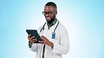 Doctor, man and tablet in studio for healthcare software, telehealth information and research on blue background. Happy african medical worker, digital technology and review online results with app 