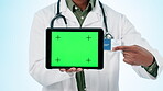 Doctor, hands or green screen on tablet for advertising healthcare app, sign up or telehealth information on blue background. Closeup, medical person or pointing to digital tracking markers in studio