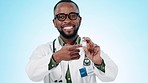 Black man, doctor and pointing to vaccine or medicine for cure or advertising against a studio background. Portrait of happy African male person, medical or healthcare professional showing antibiotic