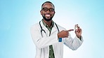 Black man, doctor and pointing to vaccine in healthcare advertising or cure against a studio background. Portrait of happy African male person, medical or healthcare professional showing antibiotic