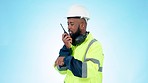 Walkie talkie, industry and man construction worker in studio with argument or fighting. Upset, angry and African industrial engineer talking on portable radio for communication by blue background.