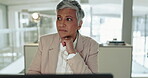 Mature, thinking and business woman on laptop in office, planning and problem solving. Computer, doubt and serious ceo reading email, decision making and brainstorming solution, question and idea