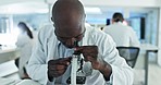 Research, microscope or black man scientist in laboratory for particles, medical analysis or test experiment. Healthcare, investigation or expert with technology for future development or results 