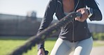 Fitness, ropes and black woman doing workout in nature for strength, weight loss and body training. Sports, wellness and young African female athlete doing exercise at an outdoor park or field.