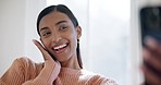 Excited, selfie and young woman at her home with positive, good and happy attitude for self love. Wink, happiness and Indian female person taking a picture with cosmetic makeup in modern apartment.