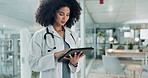 Tablet, doctor and hospital woman reading medicine study, cardiology report and check healthcare data, insight or statistics. Scroll, analysis and medical surgeon, nurse and clinic worker search web