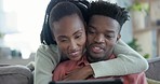 Tablet, hug and happy black couple on sofa in home living room, bonding for support and love. Smile, man and woman embrace with tech for internet, communication and scroll on social media together