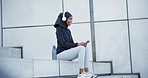 Music, outdoor and muslim woman on urban steps after fitness, run and workout in city. Hijab, phone and radio streaming with web audio and podcast for training and exercise with an athlete and smile