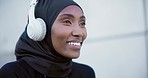 Woman, smile and headphones for listening to song, funny and hearing a joke on break from run. Happy muslim person, freedom and streaming an audio, podcast and sound with modest sportswear or hijab