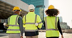 People, back and architect team walking in city for construction, maintenance or building on site. Rear view of employee group, engineer or contractor in teamwork for architecture project or plan