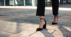 Walking, feet and person in an office for work, arriving at office or working in corporate. Ground, closeup and an employee with shoes, legs and heels in the workplace for a career or formal fashion