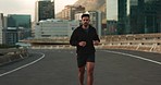 Running, fitness and face of man in city for marathon training, exercise and cardio workout. Sports, runner and portrait of person in road for performance, endurance and wellness for competition race