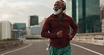 Senior man, running and headphones in city, street and vision for fitness, health and wellness in retirement. Elderly African runner, urban road and training with music for inspiration in Cape Town