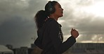 Running, headphones and woman with exercise, cardio and challenge with training, energy and endurance. Runner, person and girl with headset, practice and workout with wellness, outdoor and athlete