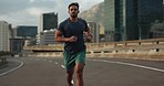 Sports, running and fitness man in a city street for marathon, training or performance, energy or resilience. Workout, challenge and male runner in road with speed, power or morning cardio exercise