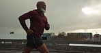 Senior African man, running and city in street, morning and vision for fitness, health and profile in retirement. Elderly runner, urban road and training with exercise, freedom or bridge in Cape Town