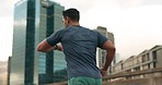 Running, fitness and man with watch in city for marathon training, exercise and cardio workout. Sports, runner and back of person in road check time for performance speed, endurance and wellness