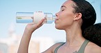 City, wellness and woman drinking water, exercise and fatigue with workout, thirsty and training. Healthy person, athlete outdoor and runner with bottle, liquid and fitness with aqua and hydration