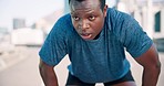 Black man, breathing or tired runner in city on road for exercise, fitness training or outdoor workout break. Face, fatigue or exhausted African athlete on street for sports or running endurance 