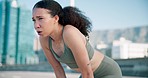 Fitness, breathing and young woman in the city for race, marathon or competition training. Sports, rest and female athlete runner sweating on a break for cardio workout or exercise in urban town.