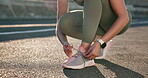 Tying laces, getting ready and a person for running, city cardio or fitness in the road. Sports, ground and a runner with shoes and feet for marathon training, exercise or a workout for health