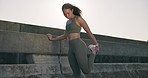 Fitness, woman and stretching legs outdoor in the city for cardio, running or exercise with sportswear. Athlete, person and runner with feet warm up and ready for morning workout or training for body