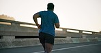 Black man, fitness and running in city for workout, outdoor exercise or cardio training in an urban town. Rear view of active male person, athlete or runner in sports, healthy wellness or lose weight