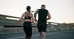 Couple, fitness and running in city for workout, outdoor exercise or training together in urban town. Rear view of active man and woman athlete or runners in sprint, cardio or sports marathon on road