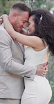 Hug, outdoor and couple with love, wedding and event with marriage, happiness and commitment. Romance, man and happy woman with groom, bride embrace outside, bonding and celebration with relationship