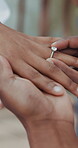 Couple, holding hands and ring for wedding, commitment or marriage union or ceremony with closeup outdoor. People, man and woman getting married for love, celebration and support with jewelry bond 