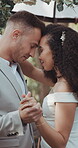 Couple, wedding and dancing with touch, nature and commitment in celebration, love and smile. Interracial marriage, fashion and happy in outdoor, peace and romance of union and trust in vertical