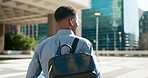 City, back and business person walking on outdoor urban journey, commute and businessman on way to office building. Backpack, morning and professional agent on morning travel to work in Chicago, USA