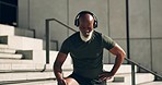 Mature man, smart watch and exercise in city with heart rate for wellness, health and thinking. African american, tired and break with podcast in outdoors, training and listening music on headphones