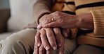 Senior, couple and hands for empathy on sofa with support, grief and comfort in living room of house. Old people, man and woman with love and embrace for security, compassion and sympathy on couch