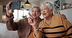 Senior couple, selfie and happy on sofa, hug or talking for choice, check post and point for photography in home. Elderly woman, man and laugh with profile profile, web blog and social media on couch