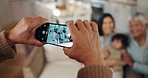 Phone, hands closeup and picture of family in living room with smile, kids and grandparent on sofa. Social media, photo and mother with a baby and grandmother happy in a house together with love