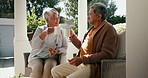 Senior couple, drinking coffee and happy in outdoors, retirement and love for bonding, marriage and trust. Smiling old mexican people, support and relax on porch with food and morning conversation