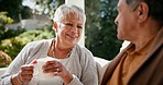 Senior couple, drinking coffee and smile in closeup, outdoors and love for bonding, marriage and trust. Retired old mexican people, support and relax on porch with food and morning conversation