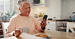 Happy senior woman, phone and coffee with funny video, social media post or streaming comedy in her home kitchen. Elderly person laughing on mobile chat, internet meme and drinking tea and cookies 