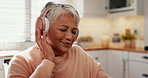 Music, relax and peace with a senior woman in the kitchen of her home streaming audio during retirement. Face, smile or peace and a happy elderly women listening to the radio with headphones